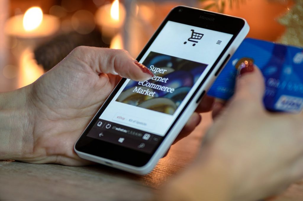 pexels-photo-230544 Person Using Black And White Smartphone and Holding Blue Card